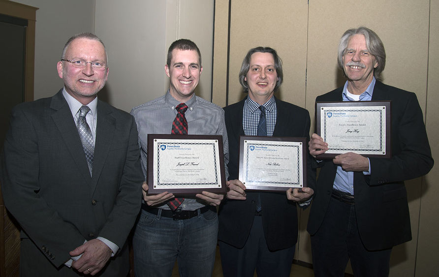 Chancellor and Chief Academic Officer Dr. Charles Patrick presented, from left, Joseph Friend Jr., Nathaniel Bohna, and Dr. Jerrold Hoeg with plaques for the Staff Excellence, Ellen Laun Advising Excellence, and Faculty Excellence awards, respectively.