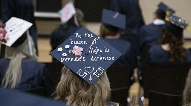 A 2019 Penn State Fayette graduate's cap reads "Be the beacon of light in someone's darkness."