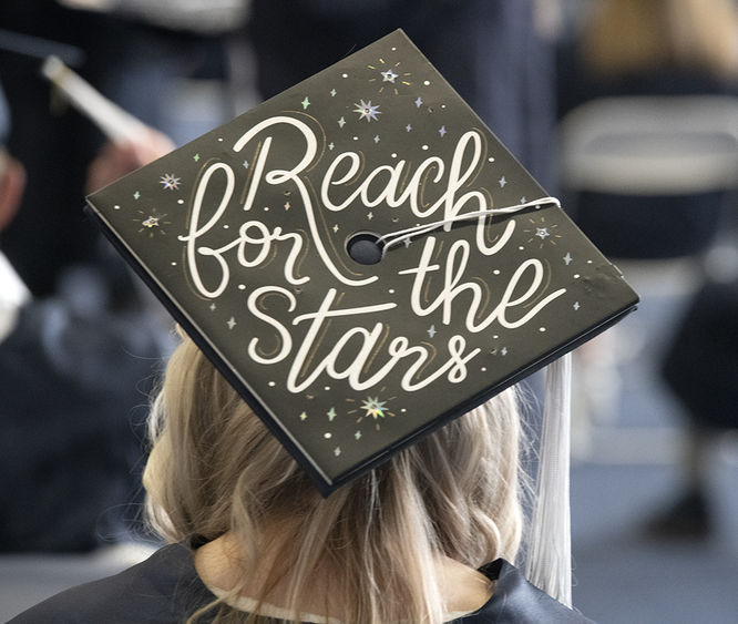 A graduate's cap reads "Reach for the stars"