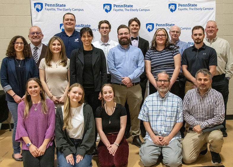 Students and faculty mentors posing at the Undergraduate Exhibition.