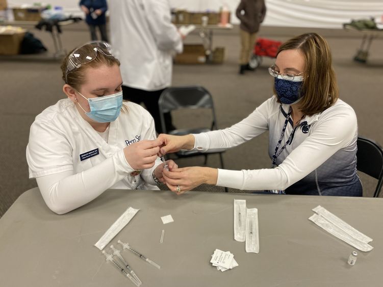 Sophomore student Shaelynn Shipley draws up a vaccine under the supervision of instructor Alison Hawk.