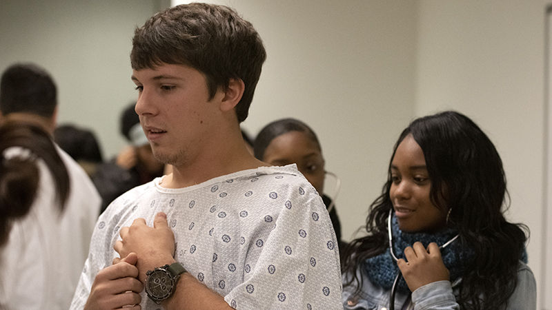 Sam Hlatky, a sophomore Nursing student at Penn State Fayette, serves as a mock patient for Imari Agurs, a junior from City Charter High School.