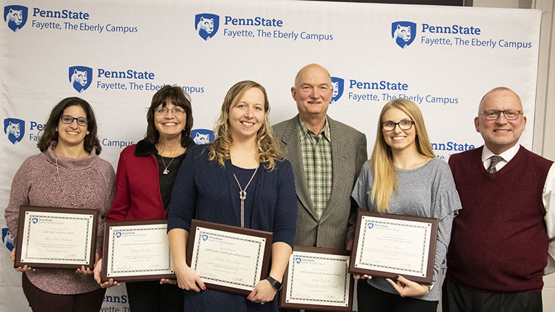 Mary Budinsky, Melissa Miner, Lindsey Simon-Jones, Andrzej Gapinski, and Rebecca Johnson accept 2019 excellence awards presented by Charles Patrick, chief academic officer and chancellor.