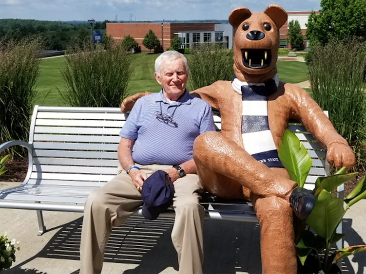 Charles E. Hunnell poses at the Penn State Fayette Lion Bench