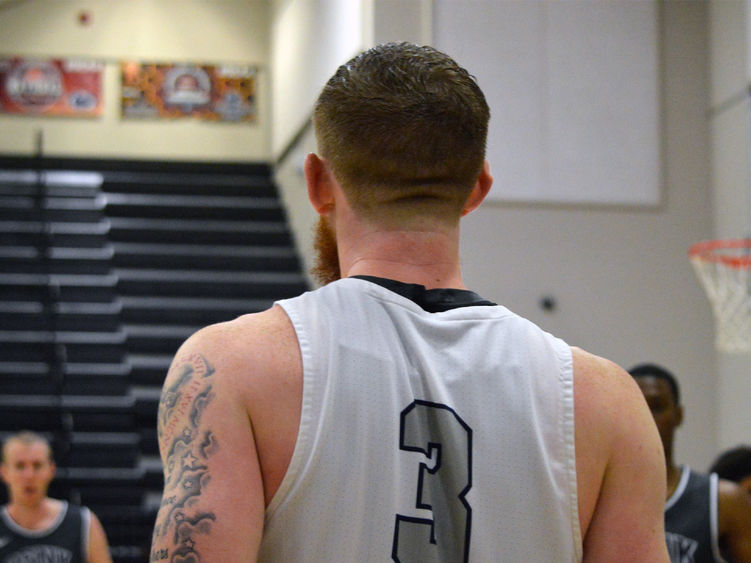 Dominic Boring on the court, photographed from behind.