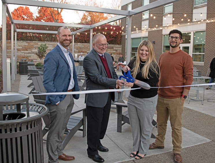 Chad Long, Charles Patrick, Maria Catalina, Joshua Simon cutting a ribbon