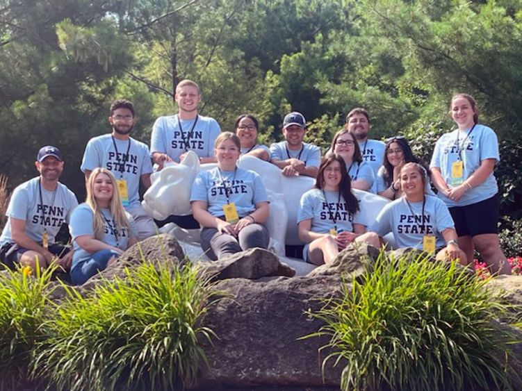 Students gathering around Penn State Behrend's nittany lion shrine.