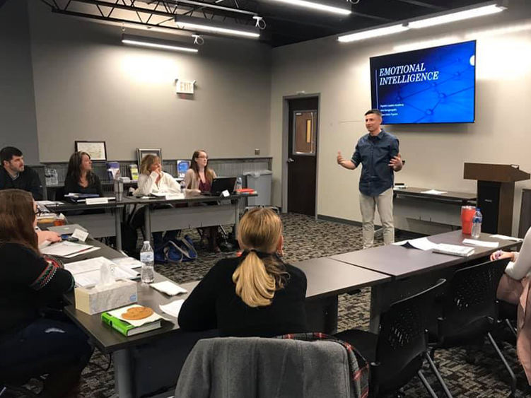 Cohort of business leaders listening to an instructor.