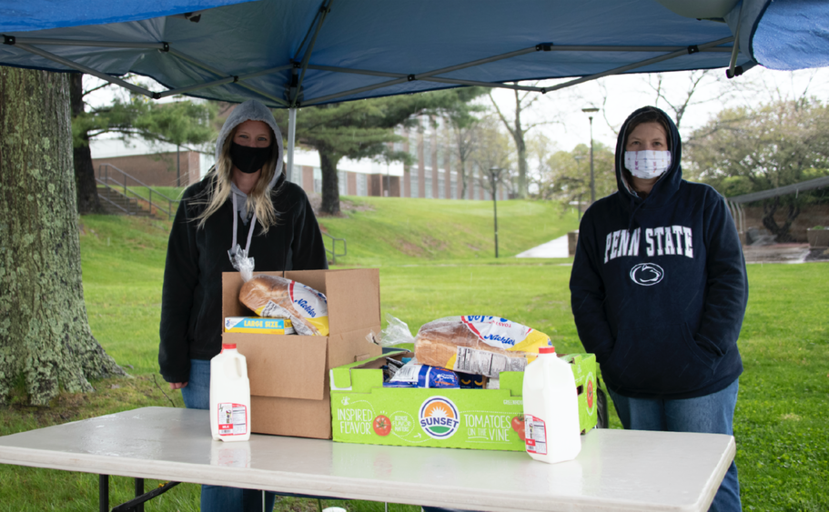 Amanda Collins, mental health counselor, and Ronette Poorbaugh, campus nurse, provide drive-thru donations from the campus food pantry to students in need.
