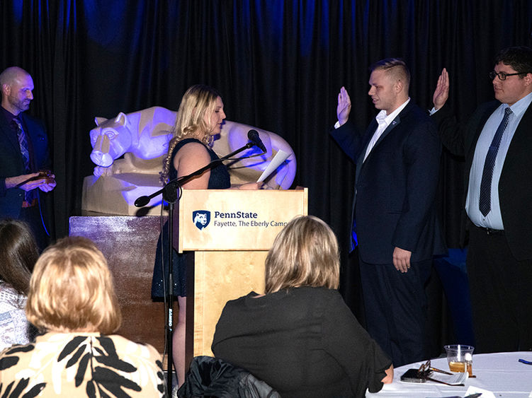 Maria Catalina swearing in Roger Myers and Jacob Mariotti in as President and Vice President of Student Government Association.