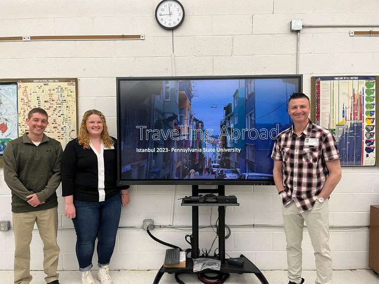 A student presenting her study abroad experience in front of a powerpoint.