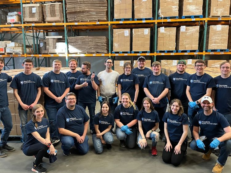 A group of students poses in the Capital Area Food Bank