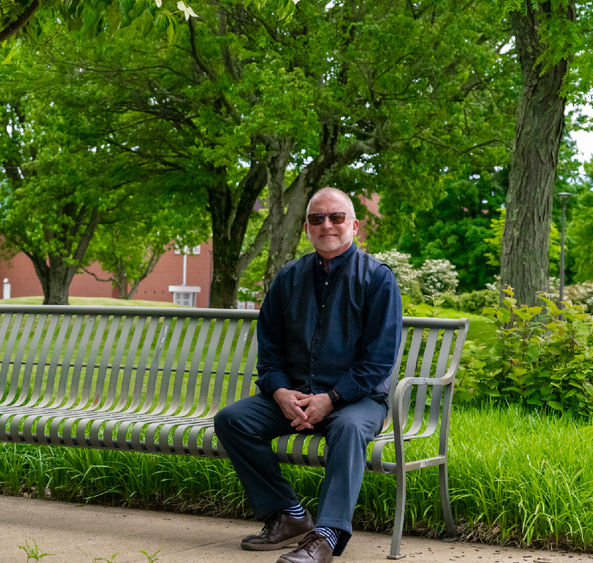 W. Charles Patrick sitting on campus.