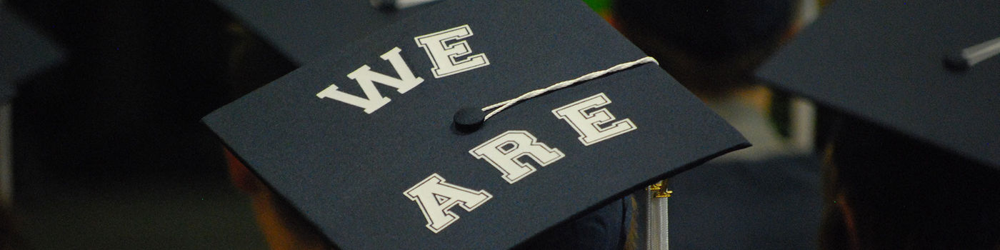 Photo of a graduation cap with "WE ARE."