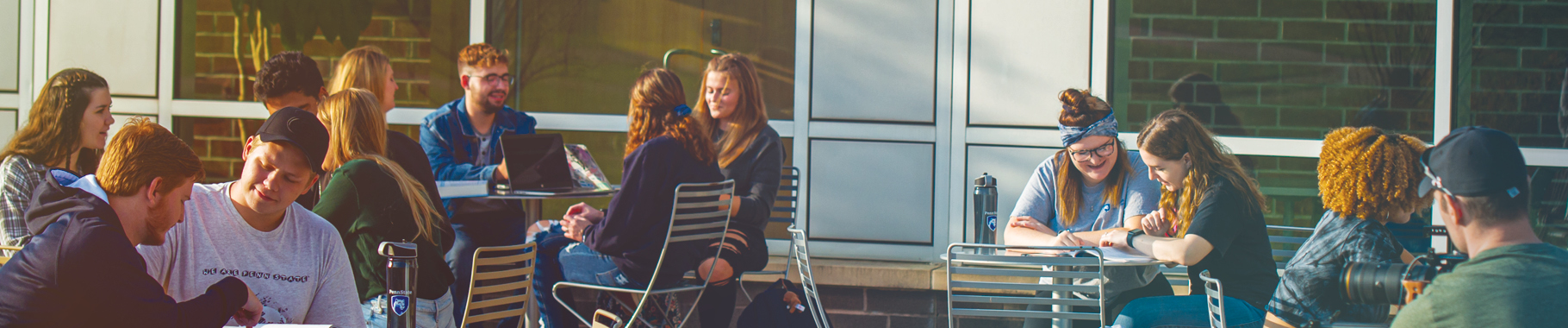 A group of students sitting outside the Fayette campus Community Center.